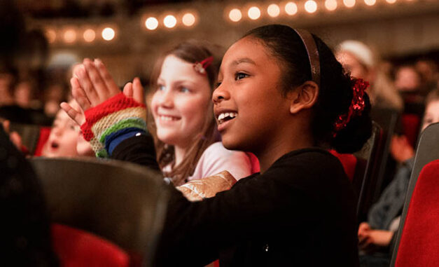 Kids in the audience clapping