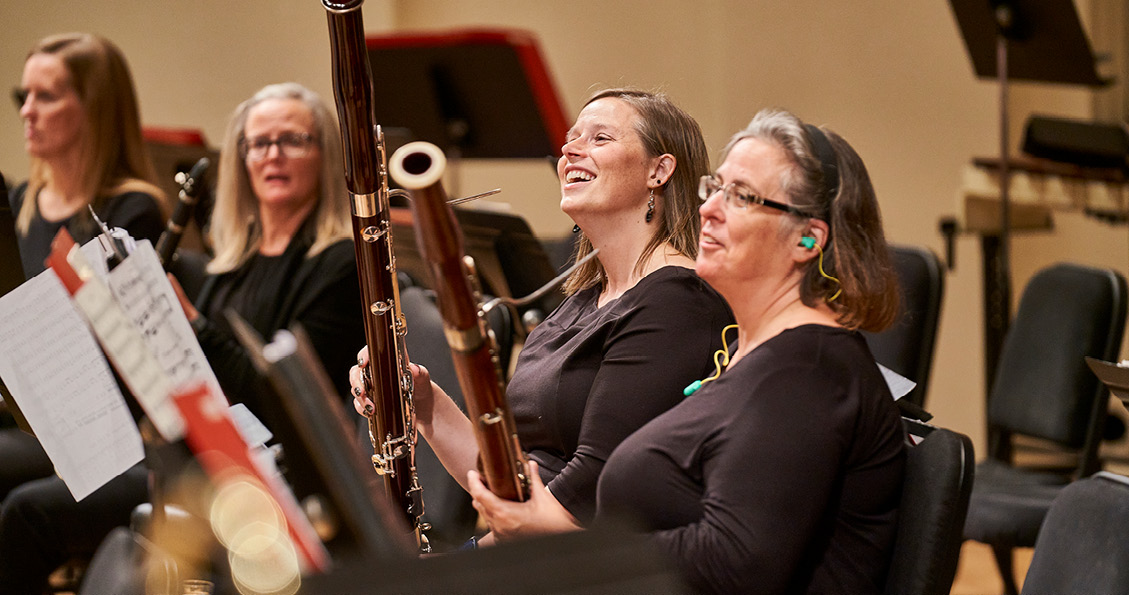 Musicians holding bassoons on stage