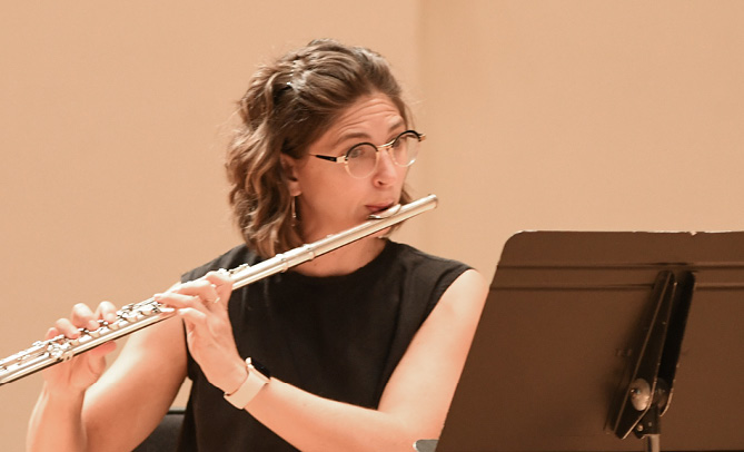 SLSO musician Ann Choomack playing the flute