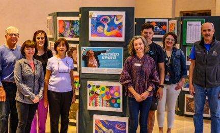 SVA members stand around "Picture the Music" exhibit