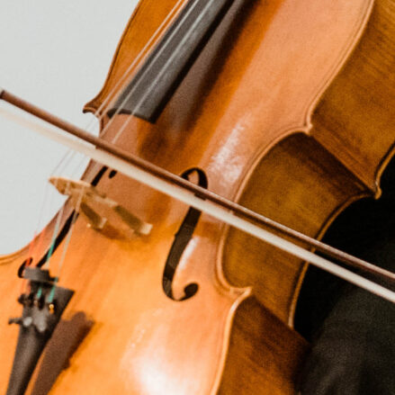 Close up of a cello being used by a cellist