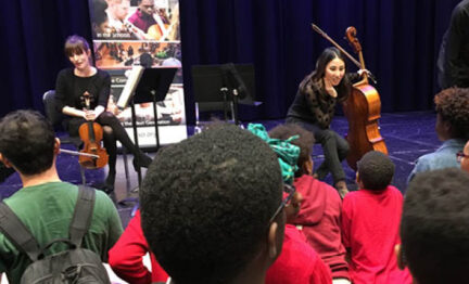 SLSO musicians talking to students from stage