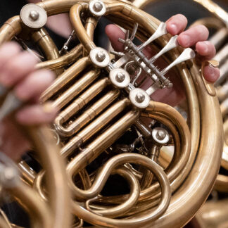 Close up of a horn being played by a horn player