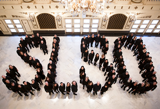 Musicians standing in foyer in shape of the letters "SLSO"