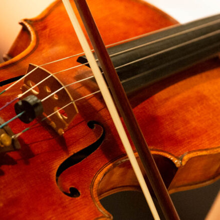 Close up of a violin being played by a violinist