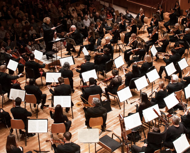 Stéphane Denève conducting orchestra members on stage