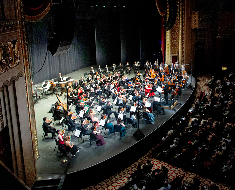 SLSO musicians playing on stage led by Music Director Stéphane Denève