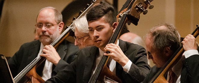 Musicians playing double basses on stage