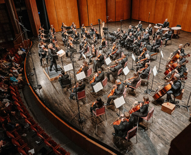 SLSO musicians playing on stage led by Music Director Stéphane Denève