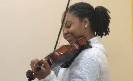 IN UNISON Academy member playing the violin