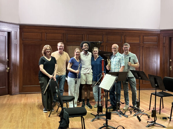 Composer with orchestra musicians